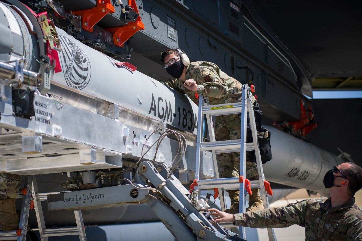 An airman helps line up an AGM-183A as it is loaded under the wing of a B-52H Stratofortress at Edwards Air Force Base, Calif. (Giancarlo Casem/U.S. Air Force)
